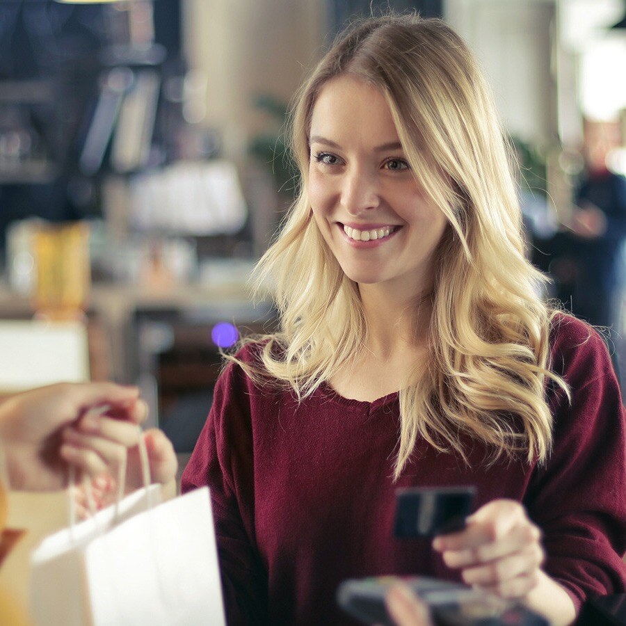 Smiling girl purchasing something with her credit card. 