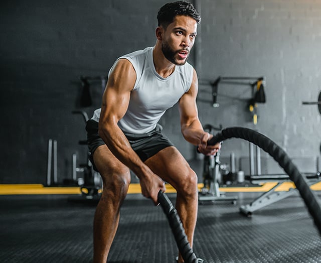 Man working out and enjoying his compass black cashback card