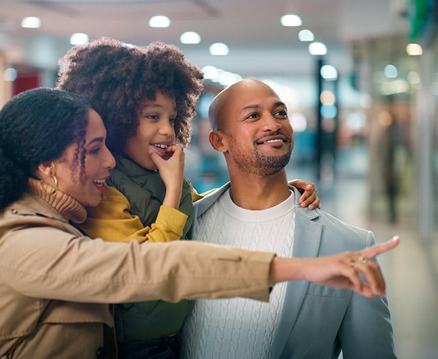 Happy family shopping and rewarding what matters with Compass Rewards from Leaders
