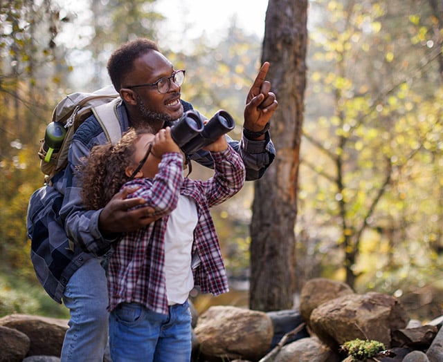 Happy older man with grandkid not worried about fraud because of protection from Leaders