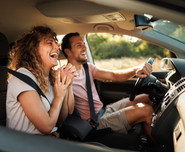 COUPLE LAUGHING IN THE CAR
